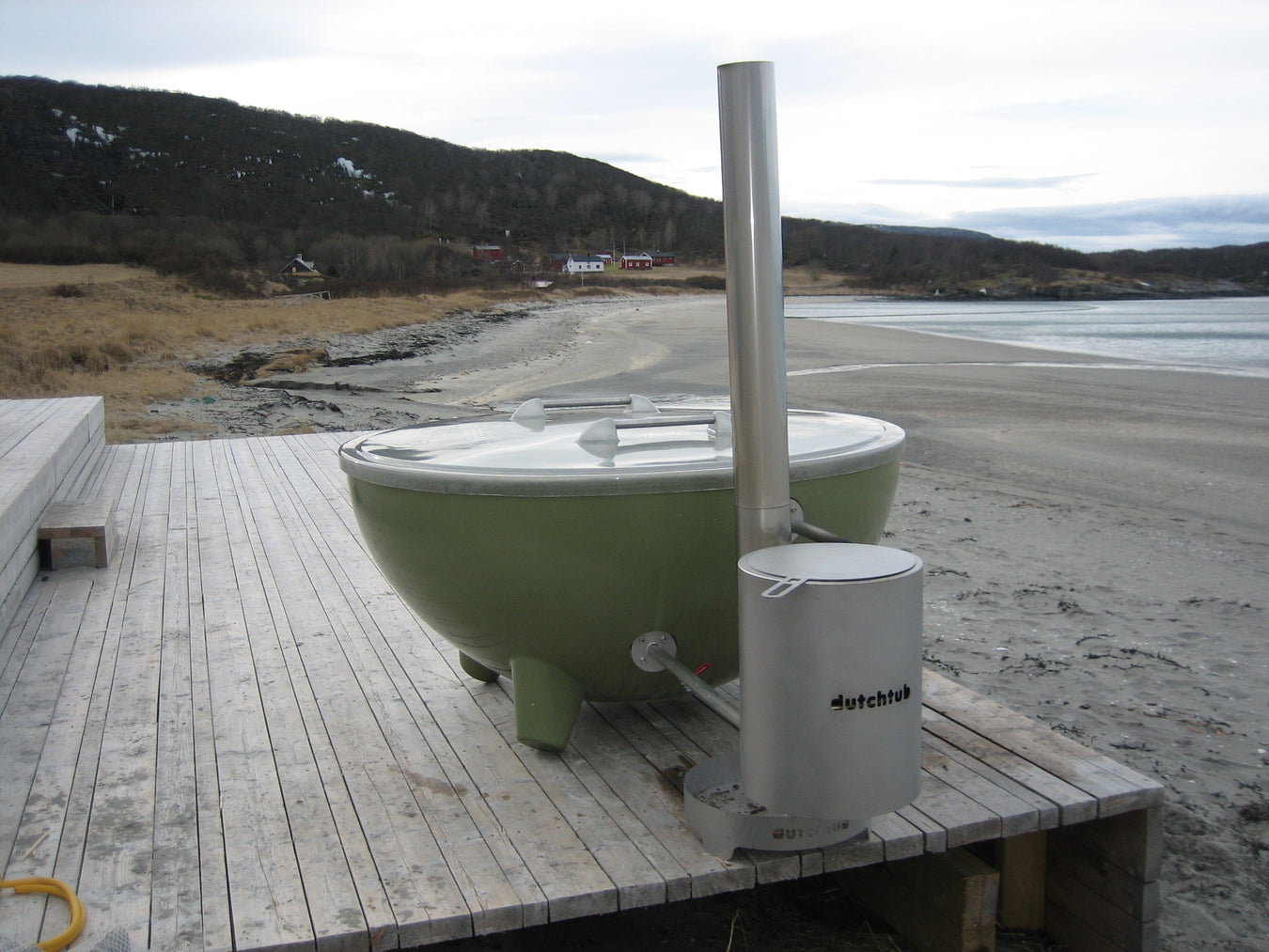 wood fired hot tub on deck next to beach