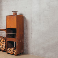 corten steel outdoor fireplace against grey wall 