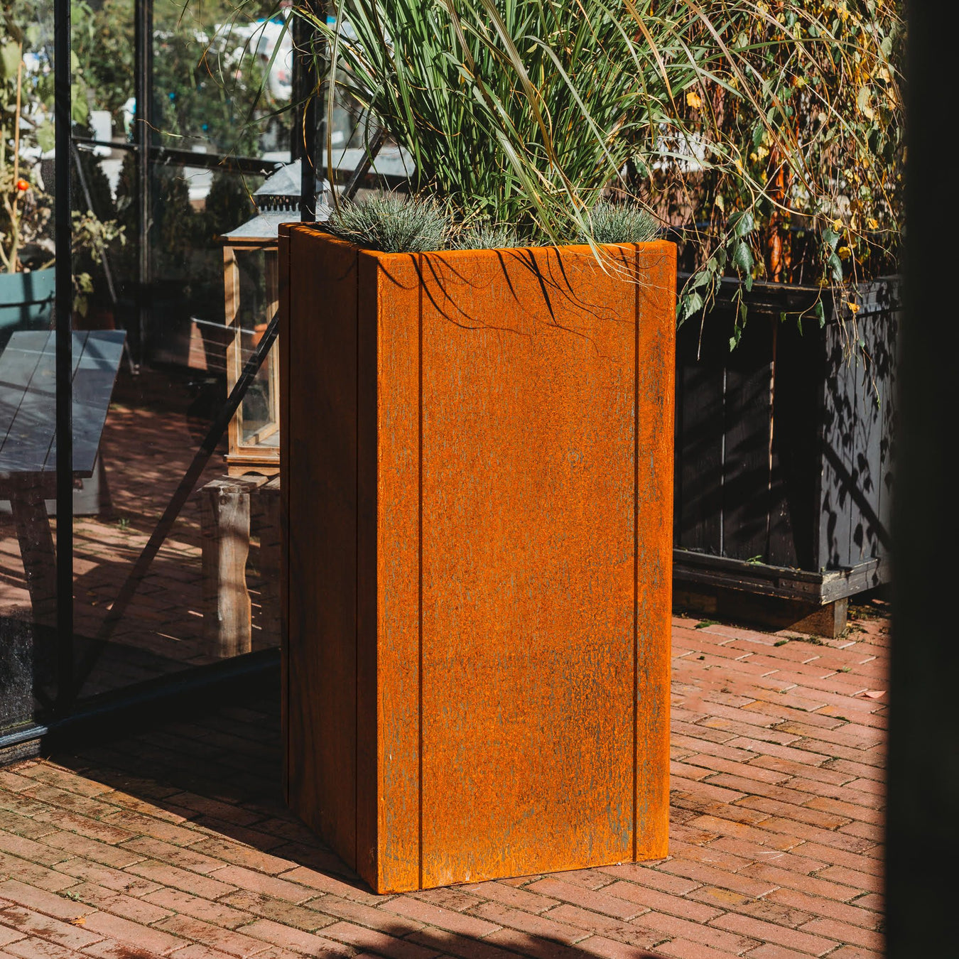 tall corten steel planter front view in garden
