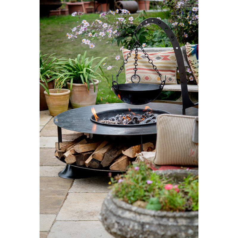 Firepits UK Flat Ring of Logs 120 with Swing Arm BBQ Rack with hanging armand bowl on patio