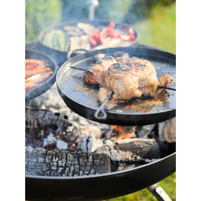 Firepits UK Plain Jane 90 with Three Swing Arm BBQ Racks close up of chicken cooking