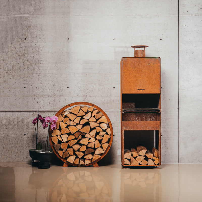 GrillSymbol Outdoor Fireplace Enzo (132x43x37cm) next to log storage