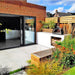 Igneus Classico Wood-Fired Pizza Oven garden image in black on patio