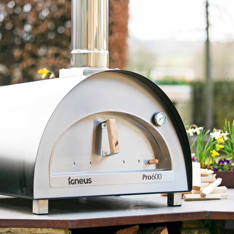 Igneus Pro 600 wood-fired pizza oven garden view with flowers