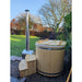 Ofuro 2 person hot tub side view in garden with wood burner and wooden cover