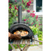 Firepits UK Table Top Pizza Oven with Turntable showing cooked pizza being removed