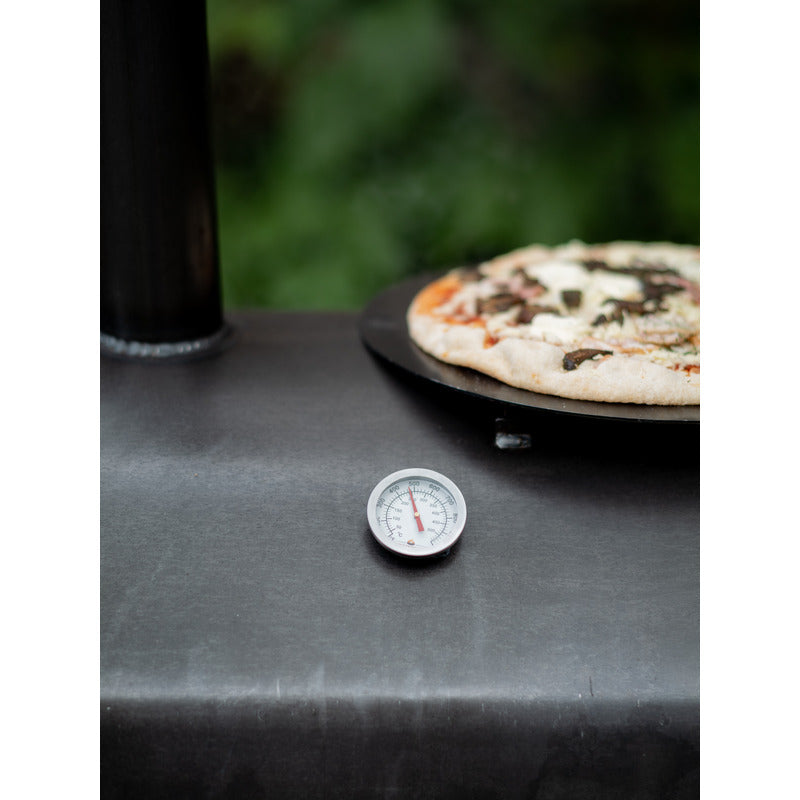 Firepits UK Table Top Pizza Oven with Turntable showing temperature gauge and cooked pizza