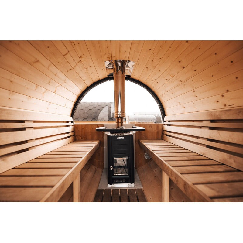 end view of benches and heater in barrel sauna