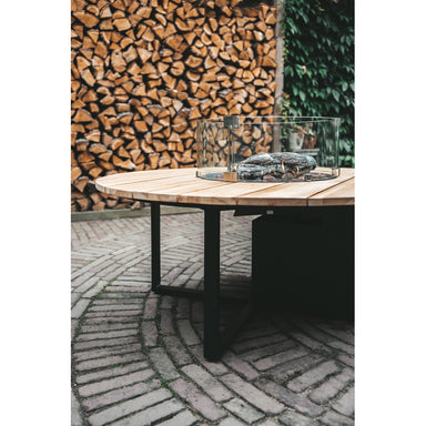 garden view of cosi round fire table in black