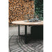 garden view of cosi round fire table in black