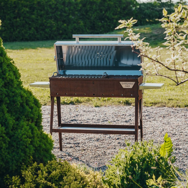 garden view of grill symbol charcoal grill with lid open