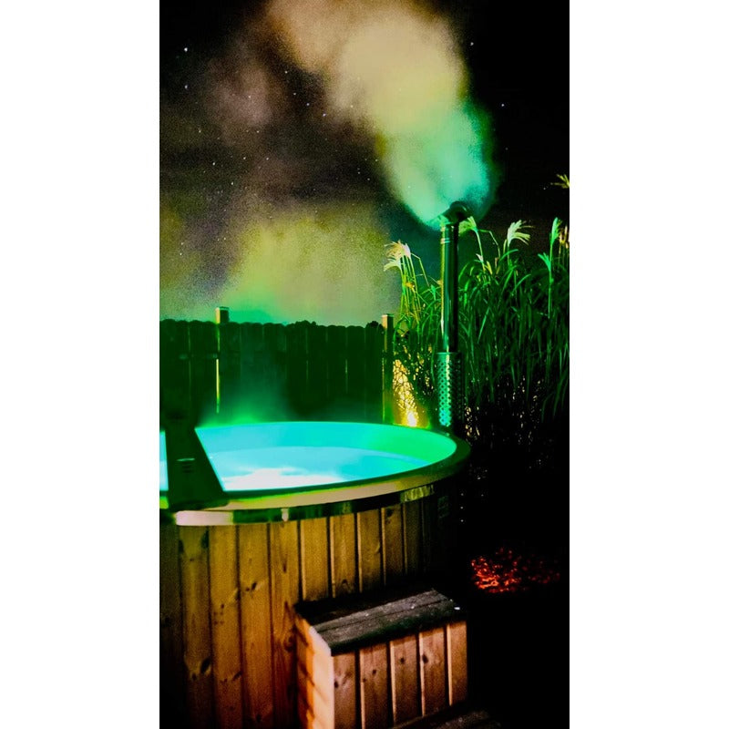 hot tub elite wood fired nightime view with led lights on 