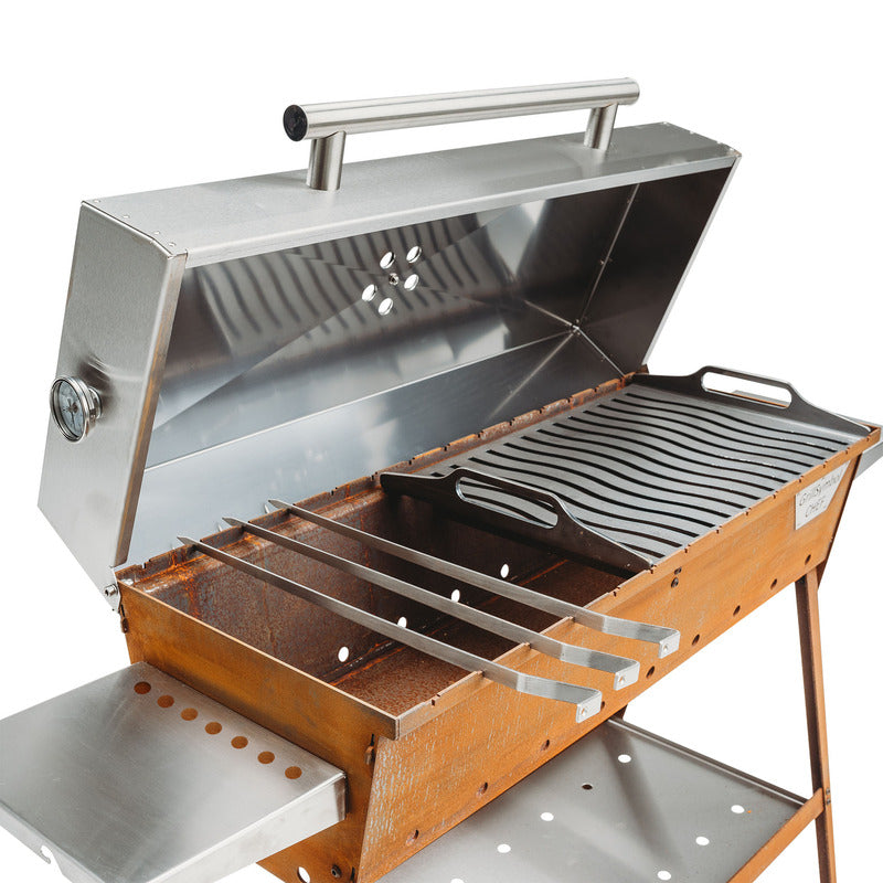 studio view of grill symbol charcoal grill lid open with skewers