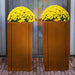 two Manhattan corten planters with yellow plants
